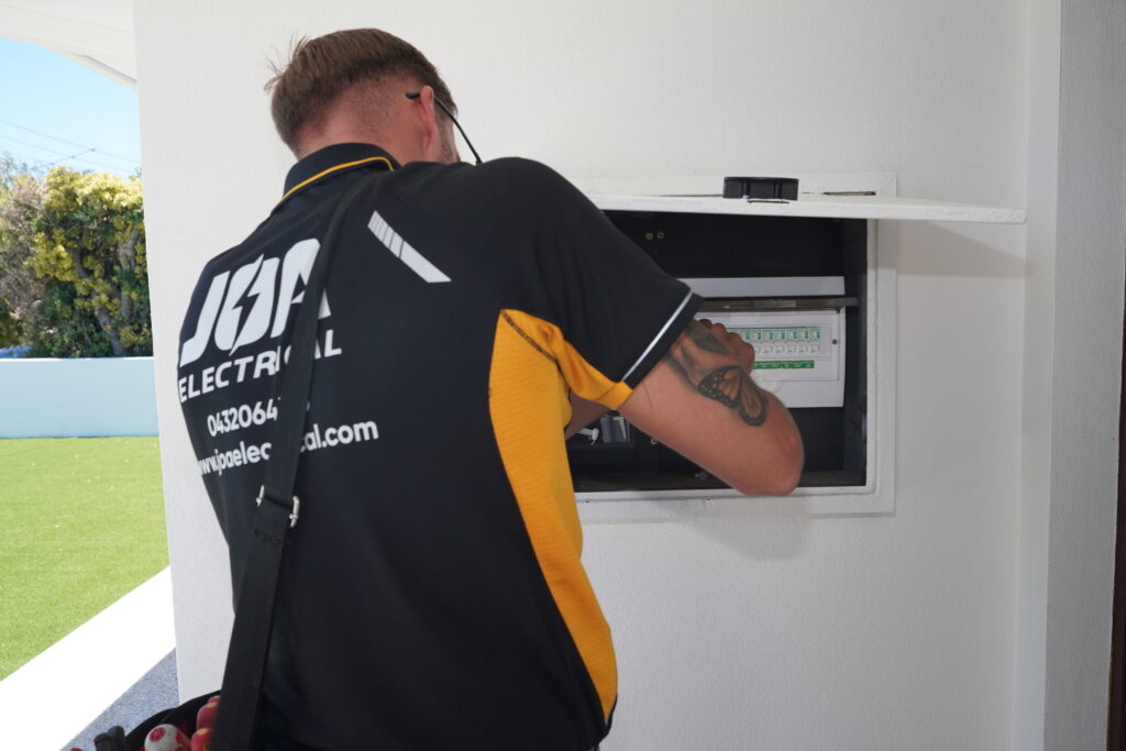 Licensed electrician servicing a residential switchboard installation