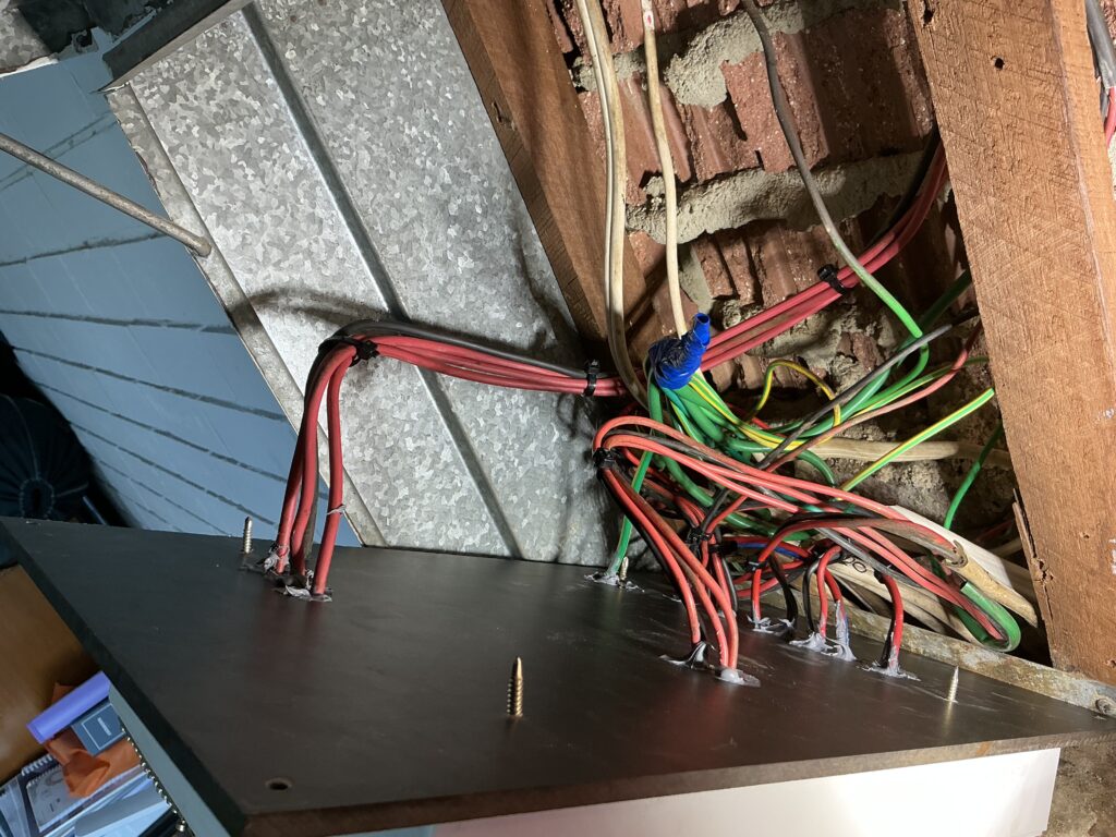 Electrical wiring exposed during residential switchboard replacement project