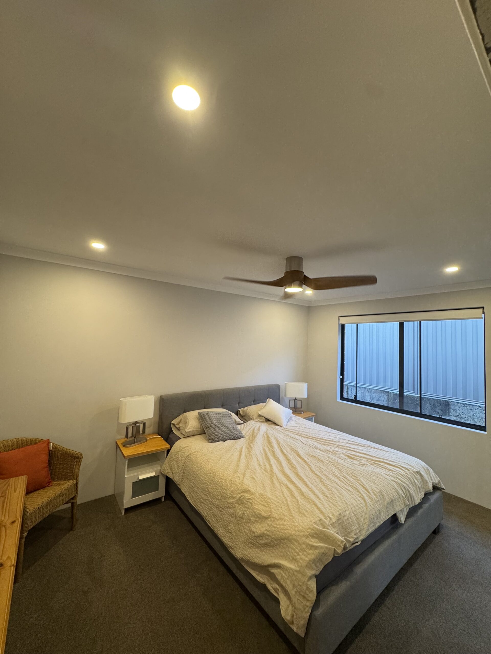Modern bedroom with ceiling fan and LED downlights