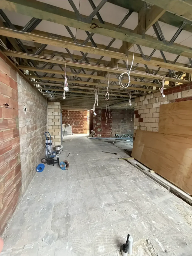 New electrical cabling roughed in through ceiling trusses during a full home rewire