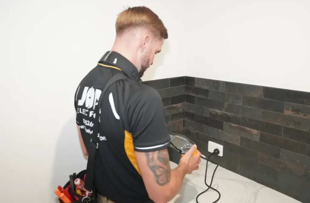 Electrician testing a newly installed power point